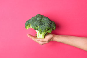 person holding broccoli